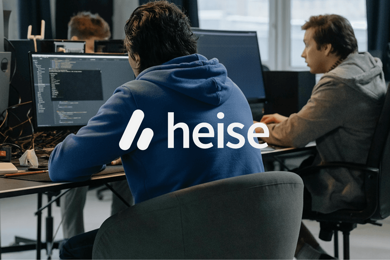heise-Logo über einer Büroaufnahme mit Mitarbeitenden an ihren Bildschirmen.