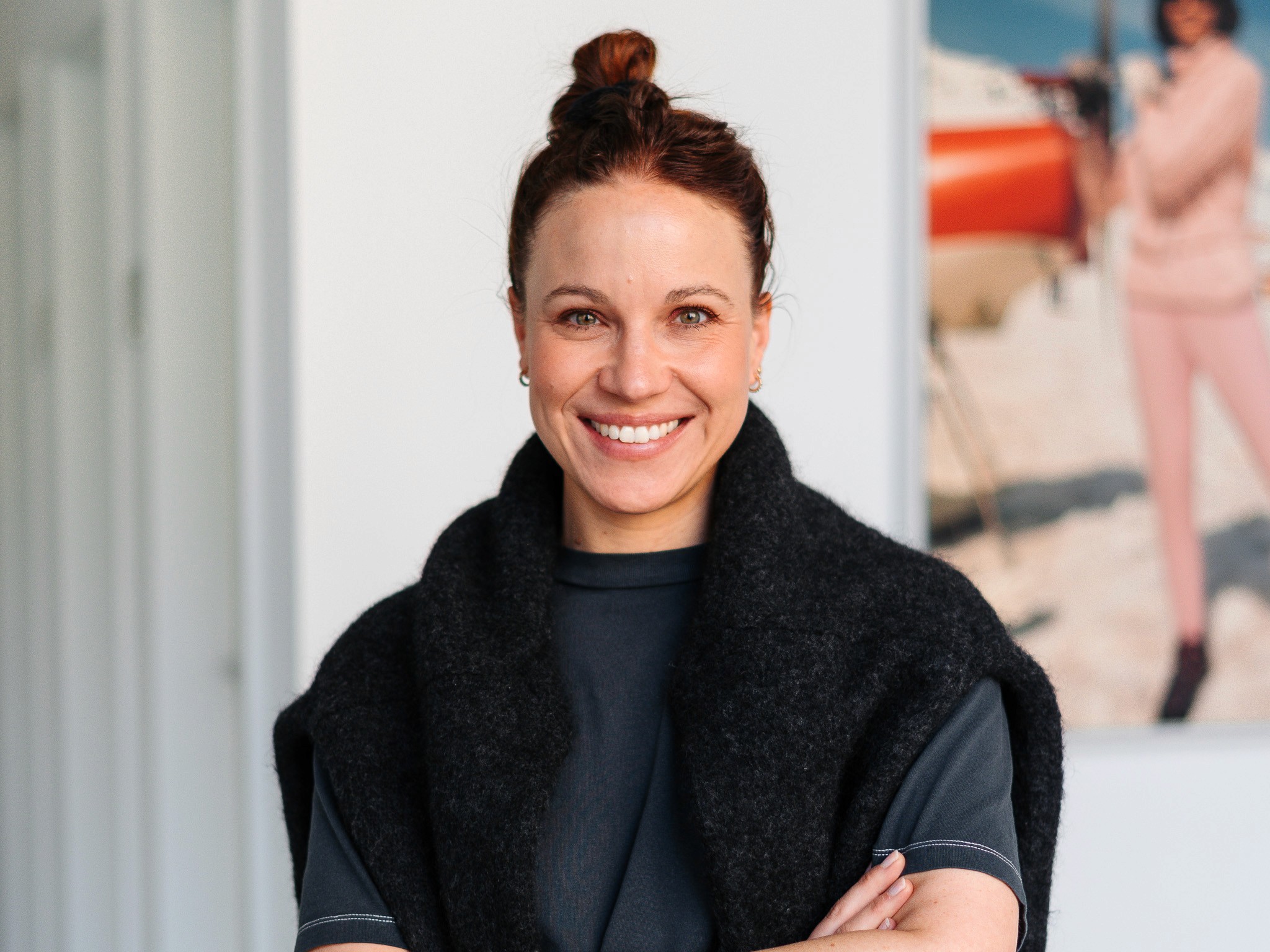 Portrait of Julia Fricke, responsible for People & Culture at DAYONE, against a light wall.