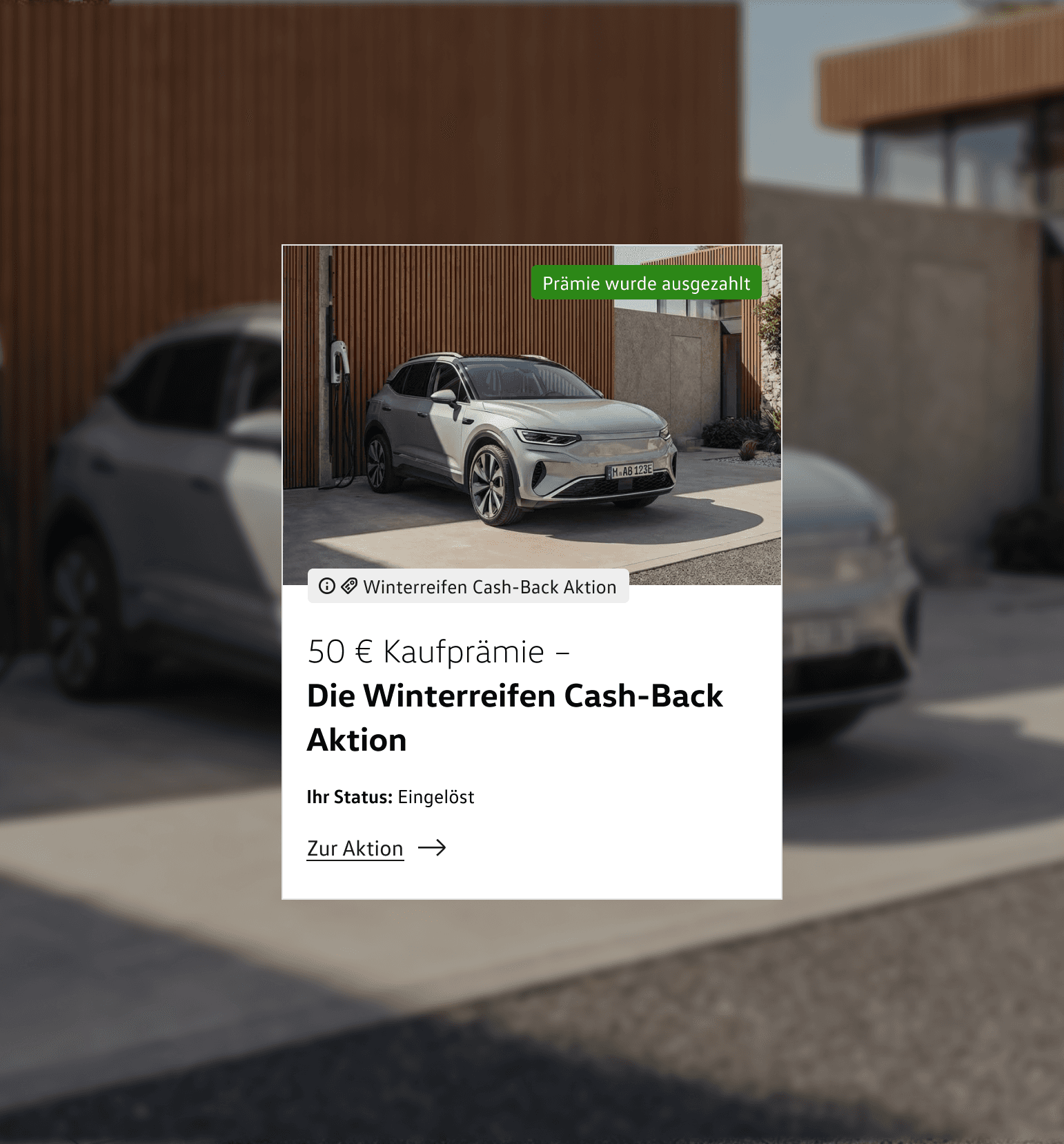 Card for a cashback promotion titled "€50 purchase bonus – the winter tyre cashback promotion". A photo of a vehicle is shown. Top right are the status "Bonus has been paid out" and a link to the promotion. In the background, the vehicle in question is visible out of focus in front of a garage.