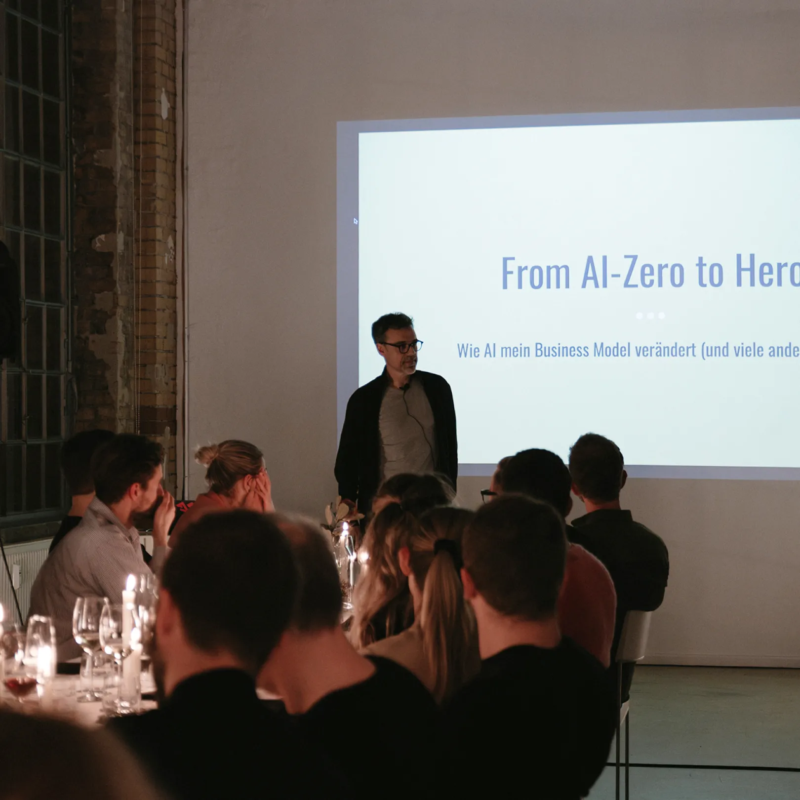 Event photo from A New Perspective with participants in conversation in a warmly lit dinner setting.